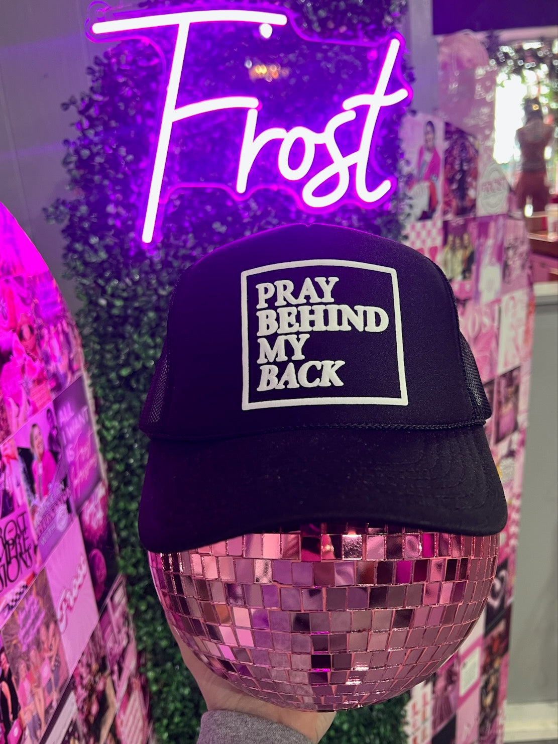 Pray Behind My Back black foam trucker hat — bold faith-inspired boutique hat from Frost Impressions Boutique in Wapakoneta, Ohio.