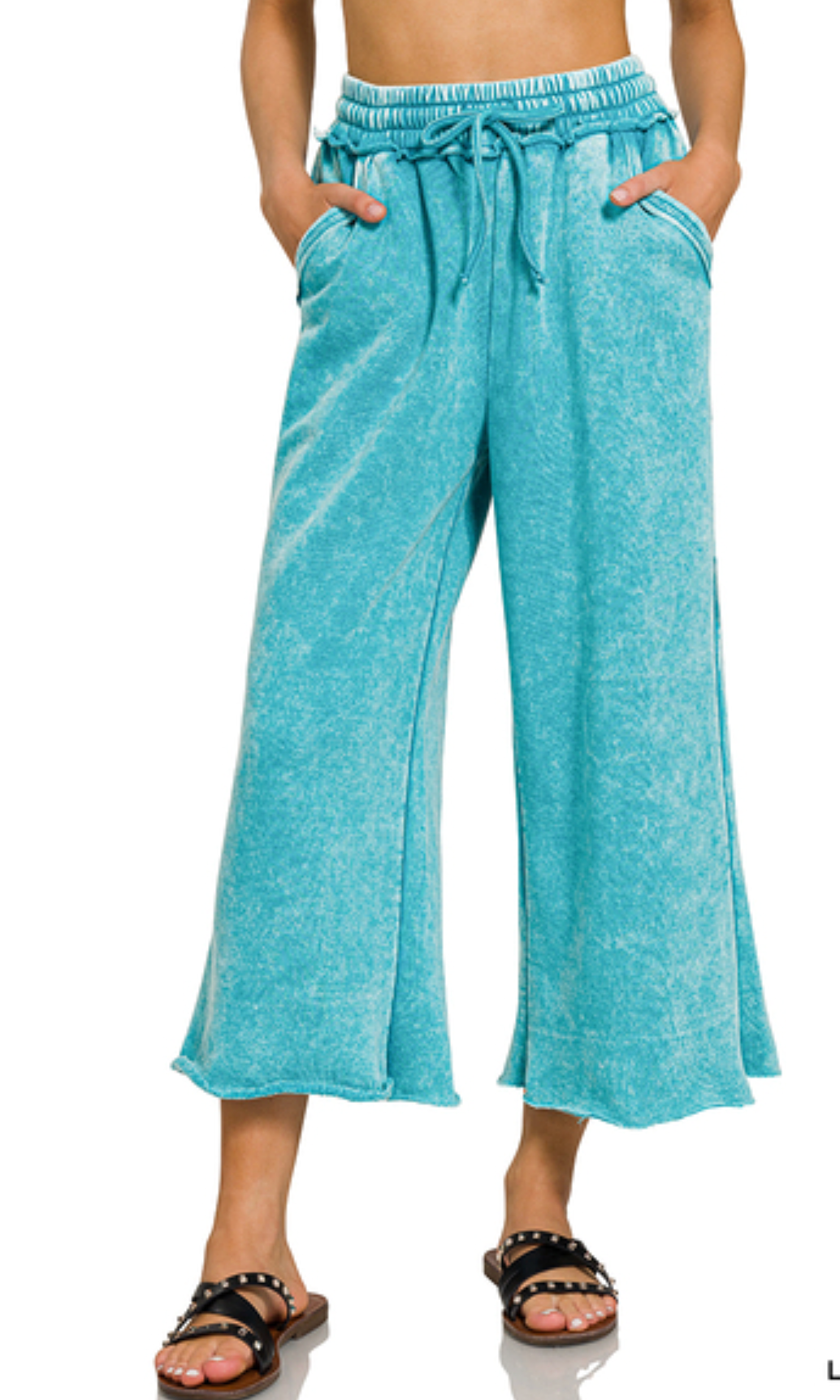 Acid wash fleece palazzo sweatpants with wide leg fit, drawstring waistband, raw hem, and side pockets available in multiple colors