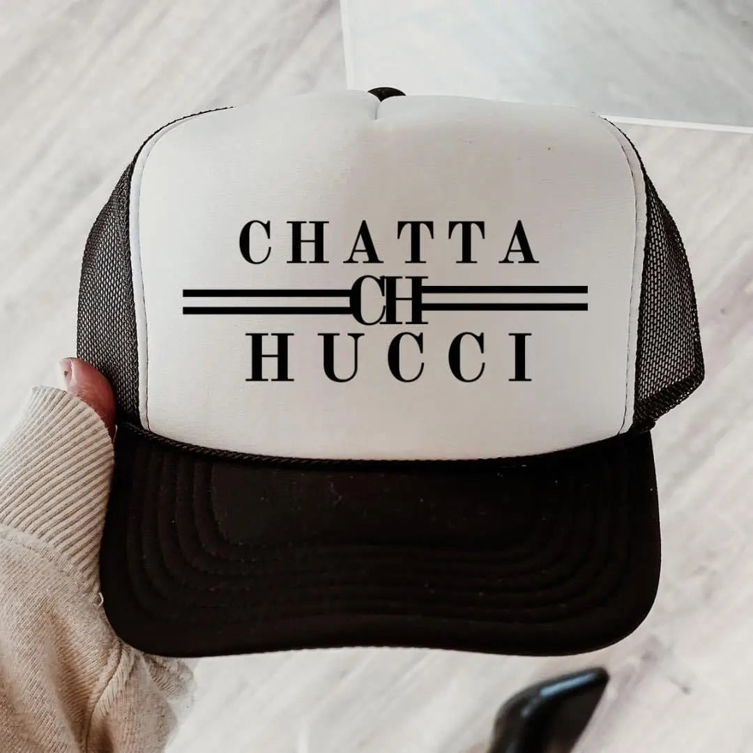 Black and white trucker hat with Chatta Hucci graphic design and mesh back
