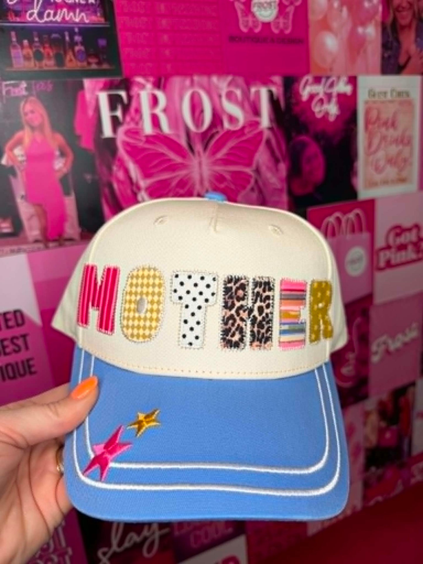 Trucker hat with MOTHER patchwork graphic design, mesh back, and casual everyday style