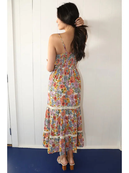 Off-white floral maxi dress with twist front detail, front cutout, and lace accents in a flowy silhouette