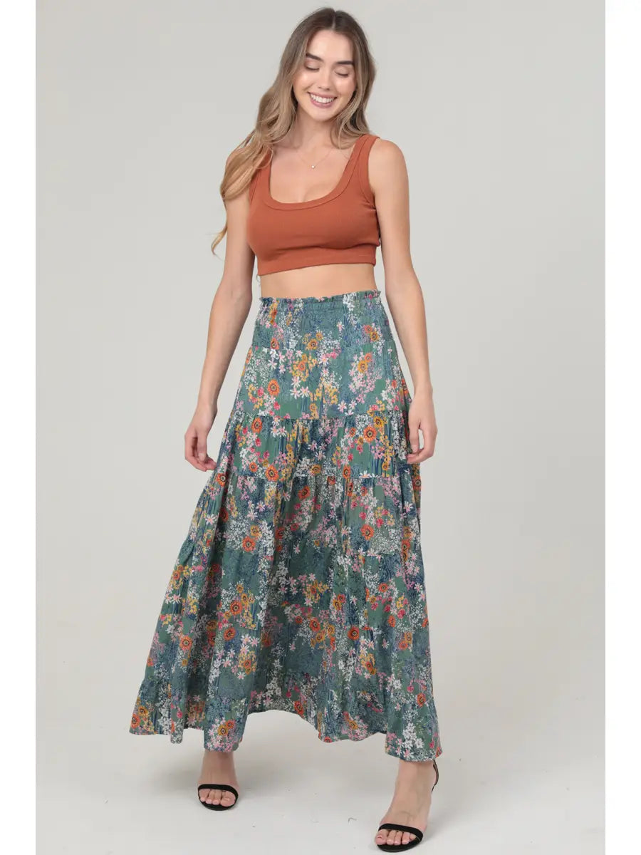 Green floral tiered maxi skirt with smocked waistband and flowy A-line silhouette