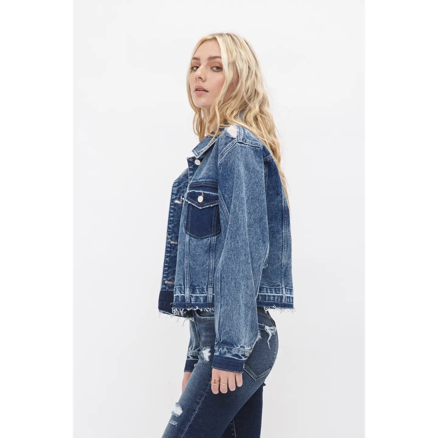 Boyfriend style cropped denim jacket with undone hem, relaxed fit, and classic button front