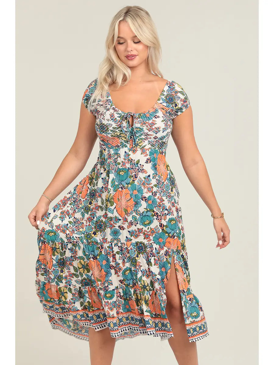 Floral smocked bodice maxi dress with crisscross back cutout detail and side slit in warm sunset tones