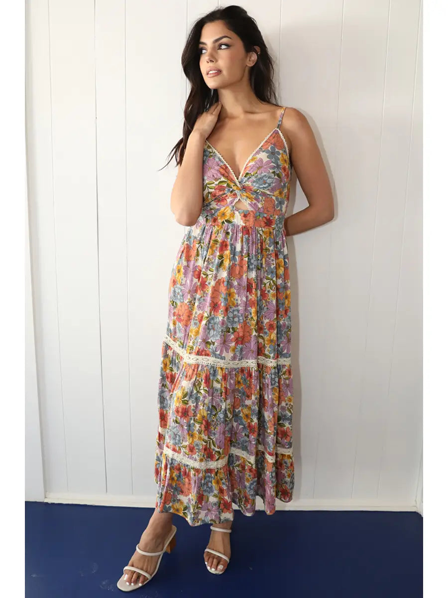 Off-white floral maxi dress with twist front detail, front cutout, and lace accents in a flowy silhouette