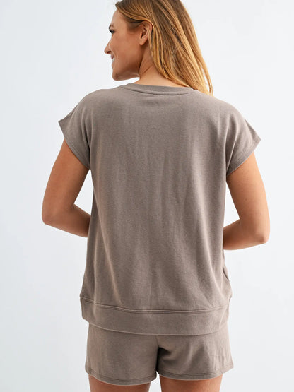 Taupe lounge set with cap sleeve top and matching shorts featuring elastic drawstring waistband and oversized pockets