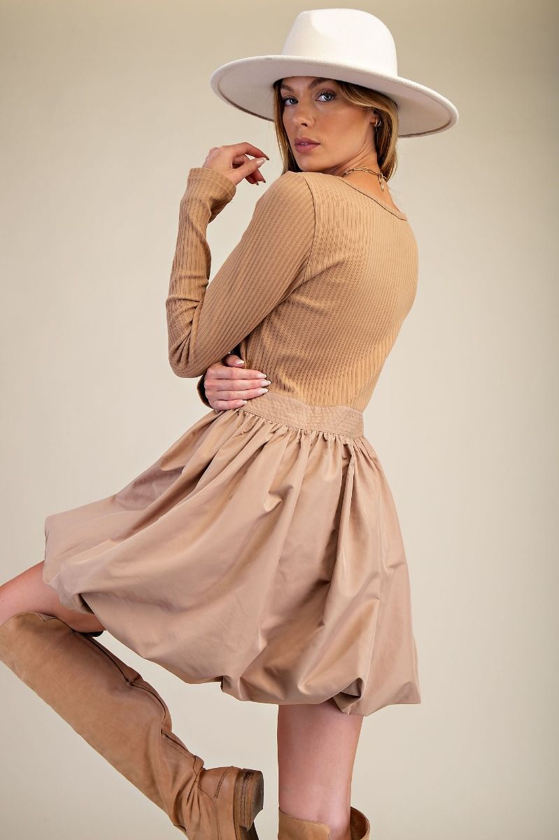 Camel Bubble Dress with bubble hem, ribbed knit bodice, wide scoop neckline, and side pockets.