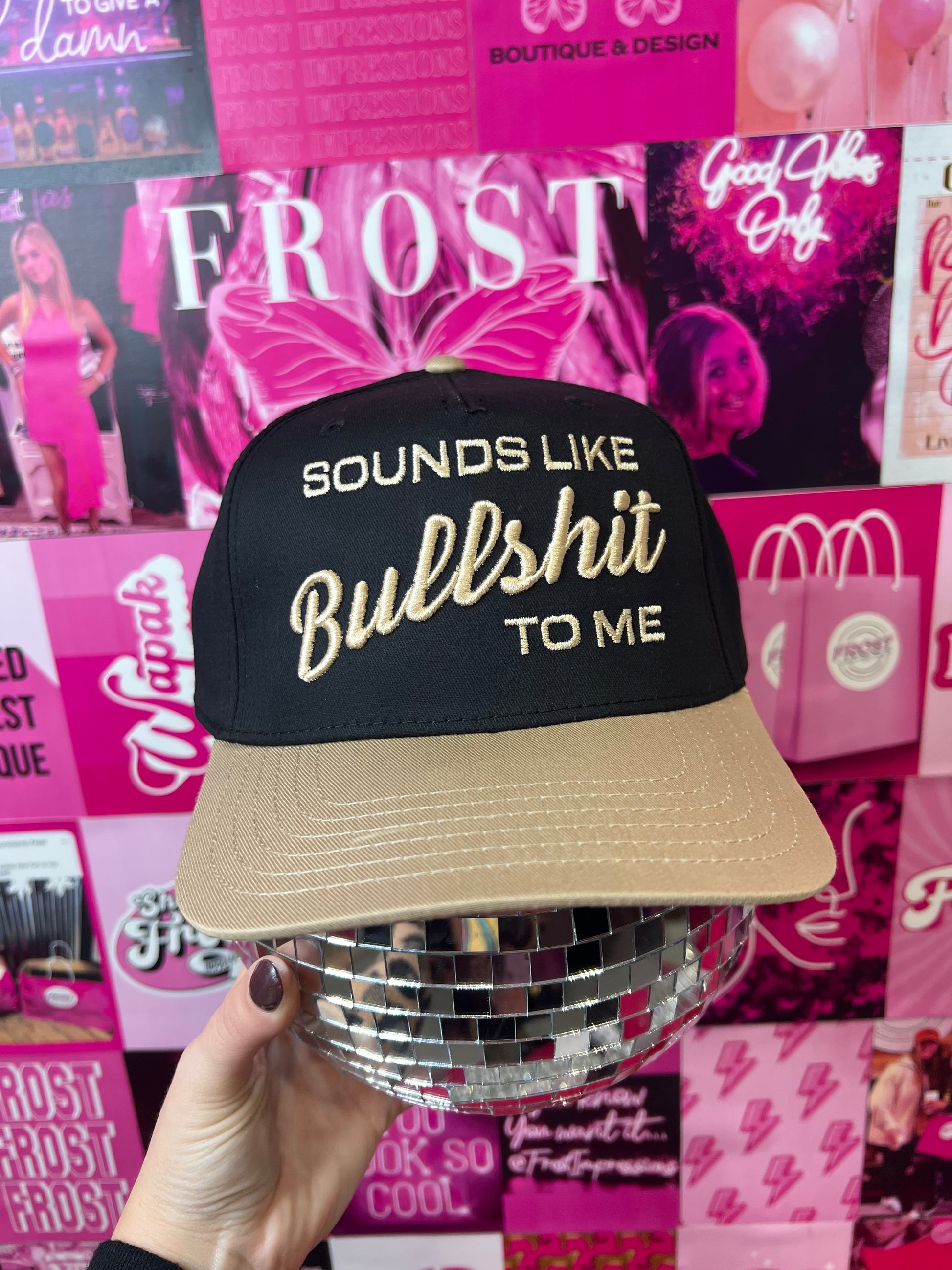 Cream and black trucker hat with bronze “Mom Club” patch — trendy boutique hat for moms.