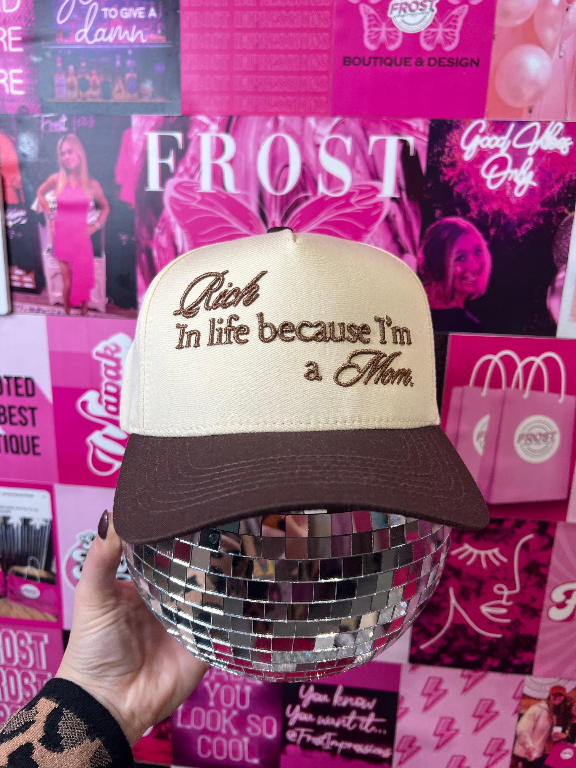 Trendy trucker hat with 3D puff embroidery text “Rich in Life Because I’m A Mom” — Rich in Life Because I’m A Mom Hat from Frost Impressions Boutique.