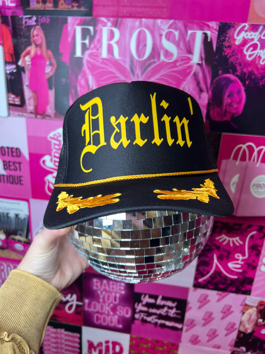 Black captain-style Otto trucker hat with “Darlin’” design — trendy boutique hat from Frost Impressions Boutique in Wapakoneta, Ohio.
