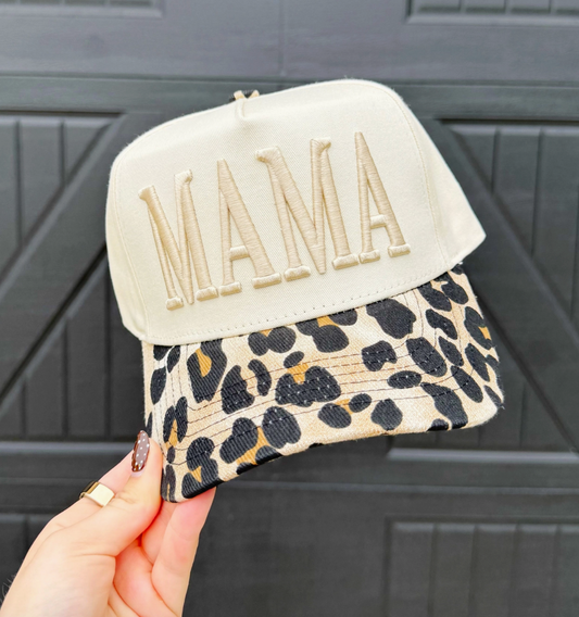 The Leopard Mama Hat features a trendy leopard print and embroidered puff stitch design — the perfect mix of bold, casual, and cute. Available at Frost Impressions Boutique in Wapakoneta, Ohio.