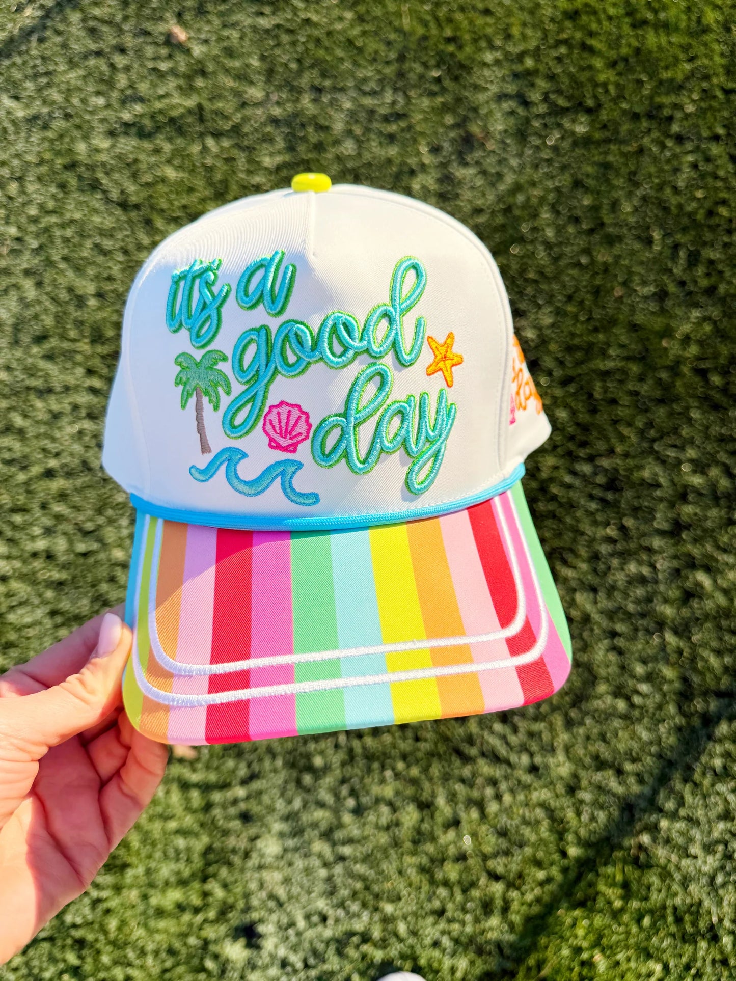 Colorful embroidered “It’s a Good Day” trucker hat with mesh back and snapback closure
