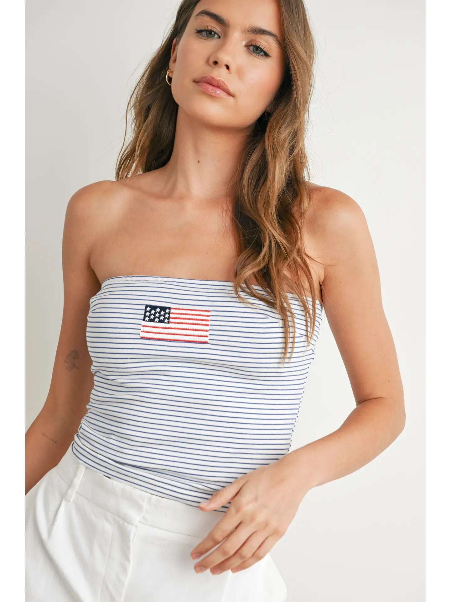 Navy striped strapless tube top with embroidered American flag detail and stretchy fit