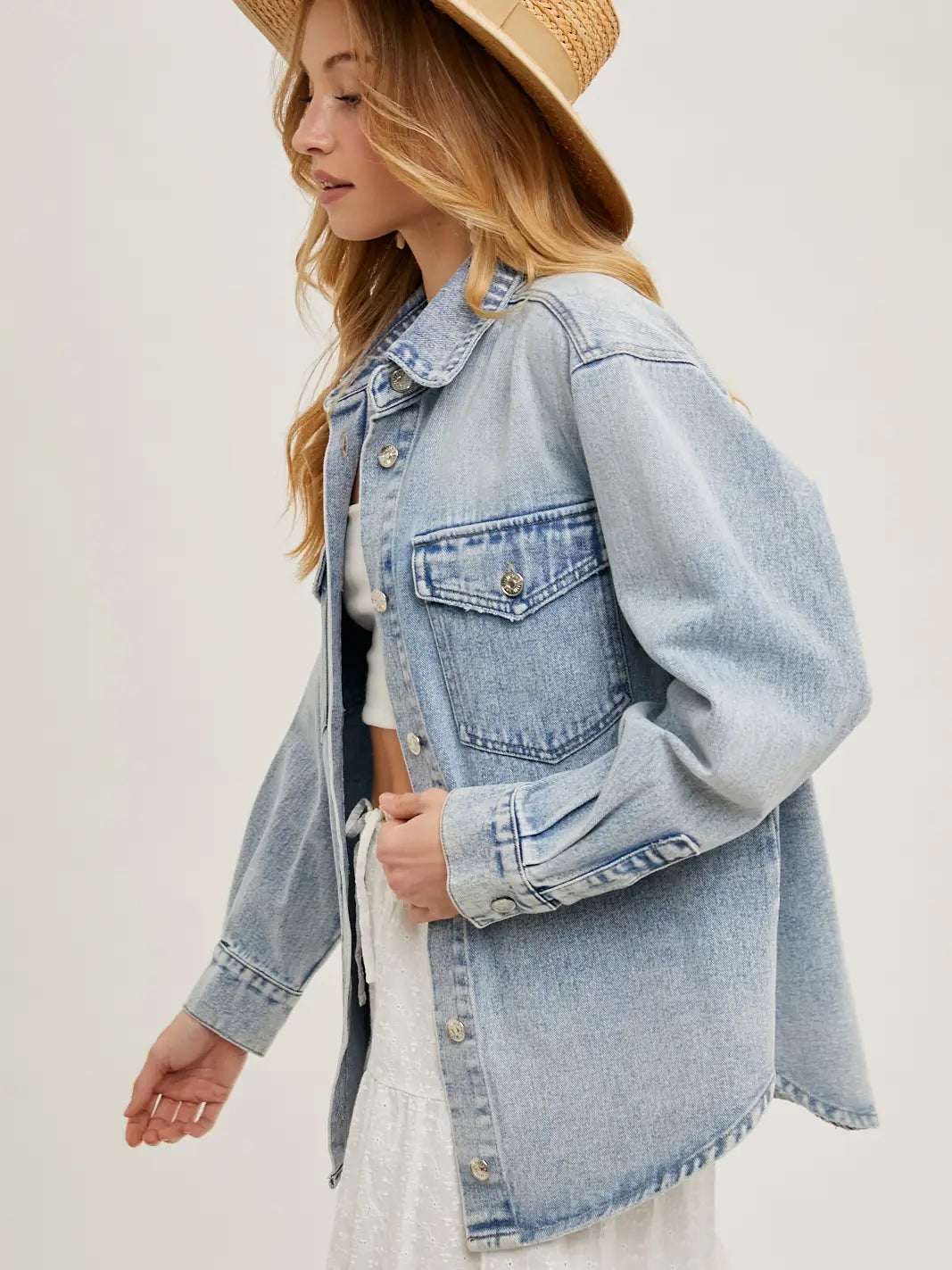 Washed denim button down shirt jacket with relaxed fit, soft fabric, and layered shacket style