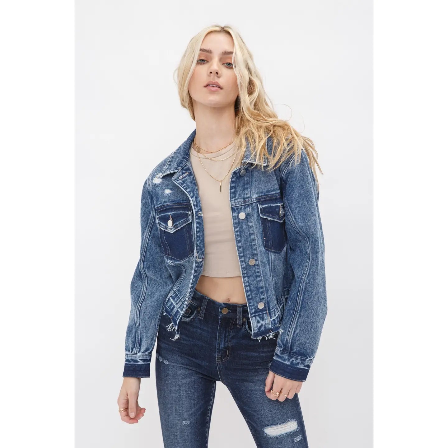 Boyfriend style cropped denim jacket with undone hem, relaxed fit, and classic button front