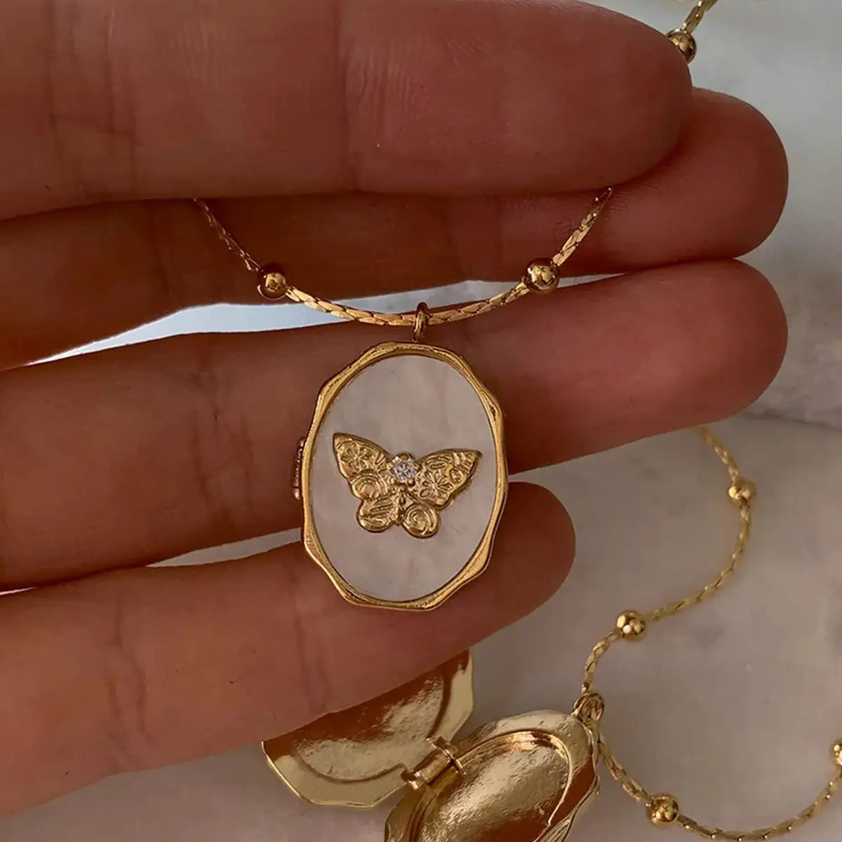 Butterfly Locket Necklace — vintage gold butterfly pendant photo locket necklace from Frost Impressions Boutique in Wapakoneta, Ohio.