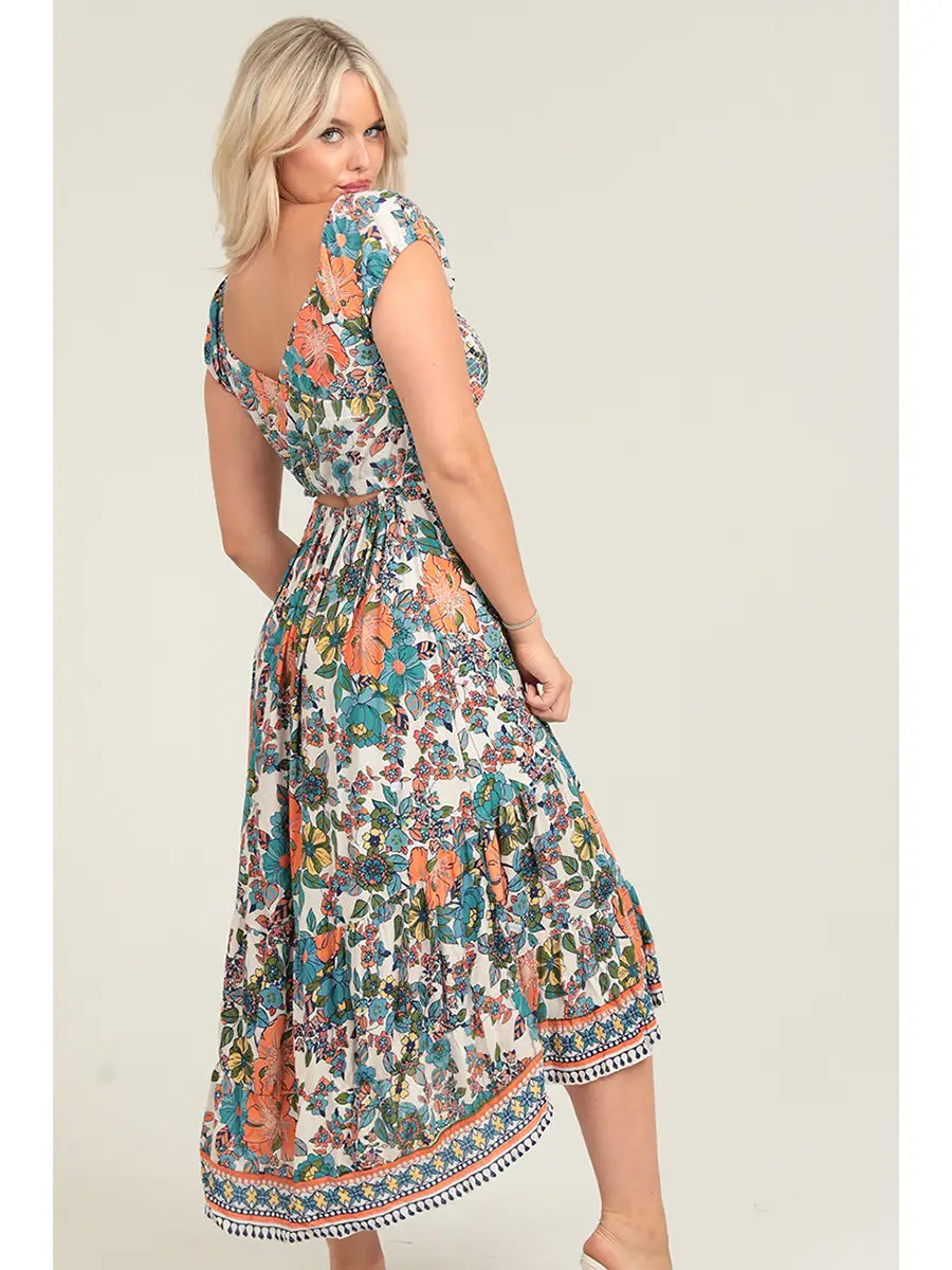 Floral smocked bodice maxi dress with crisscross back cutout detail and side slit in warm sunset tones