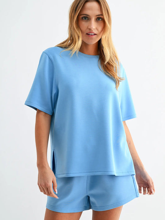 Butter soft scuba tee set with short sleeve top and matching shorts featuring elastic waistband and pockets in a relaxed fit