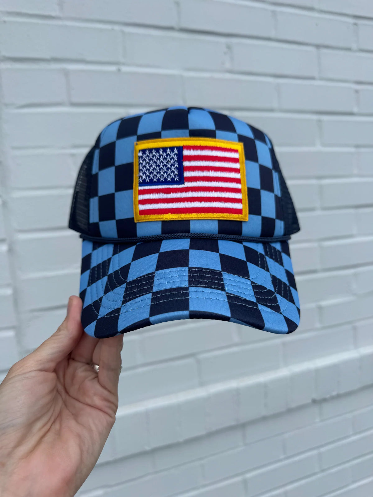 Checkered flag pattern trucker hat with mesh back and adjustable snap closure