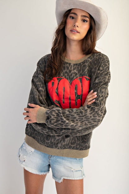 Wild at Heart leopard print mineral washed terry pullover with red “ROCK” heart graphic, oversized fit, and crew neckline.