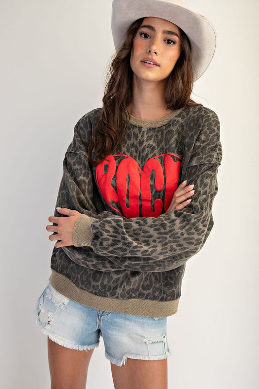 Wild at Heart leopard print mineral washed terry pullover with red “ROCK” heart graphic, oversized fit, and crew neckline.