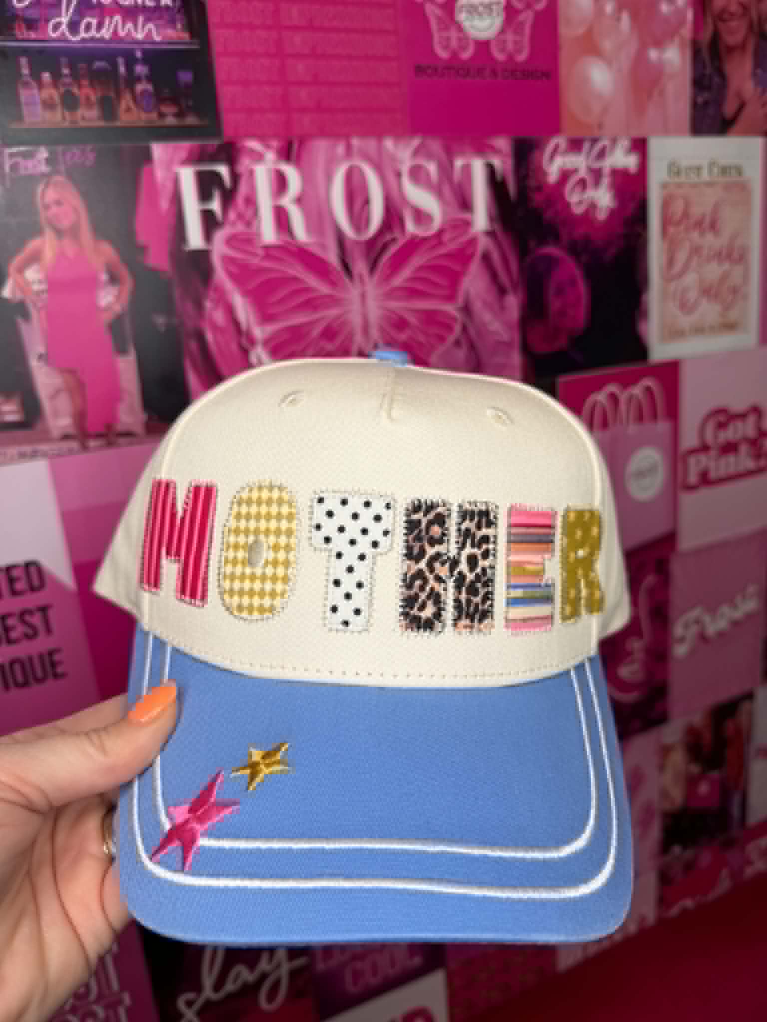 Trucker hat with MOTHER patchwork graphic design, mesh back, and casual everyday style