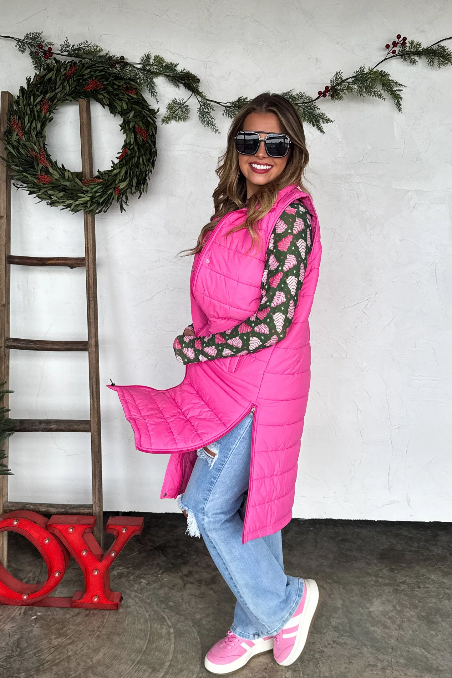Pink long puffer vest with quilted design, snap buttons, zipper closure, and working side zippers — Frost Impressions Boutique.