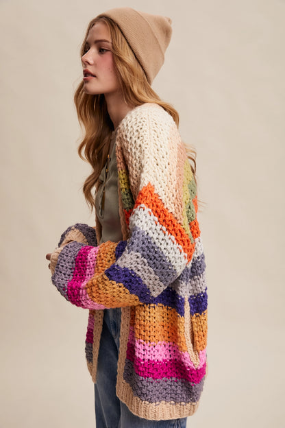 Rainbow multi crochet cardigan with chunky knit texture, balloon sleeves, and side pockets from Frost Impressions Boutique.
