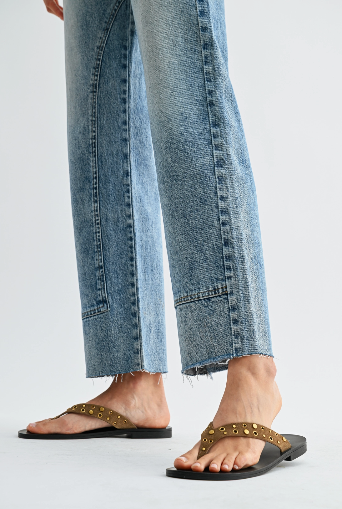 High waist straight leg jeans with studded detailing, medium wash denim, and subtle fading
