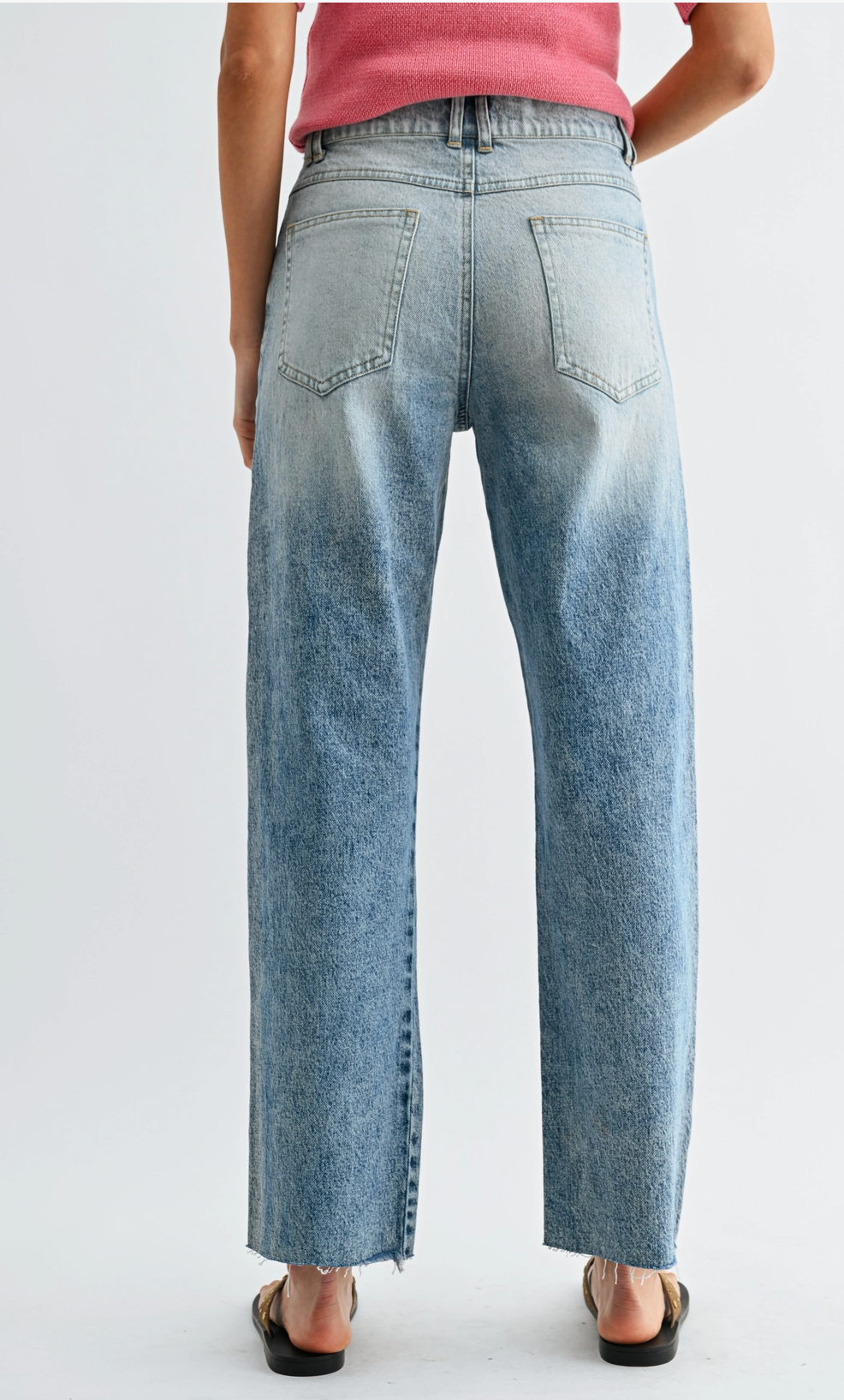 High waist straight leg jeans with studded detailing, medium wash denim, and subtle fading