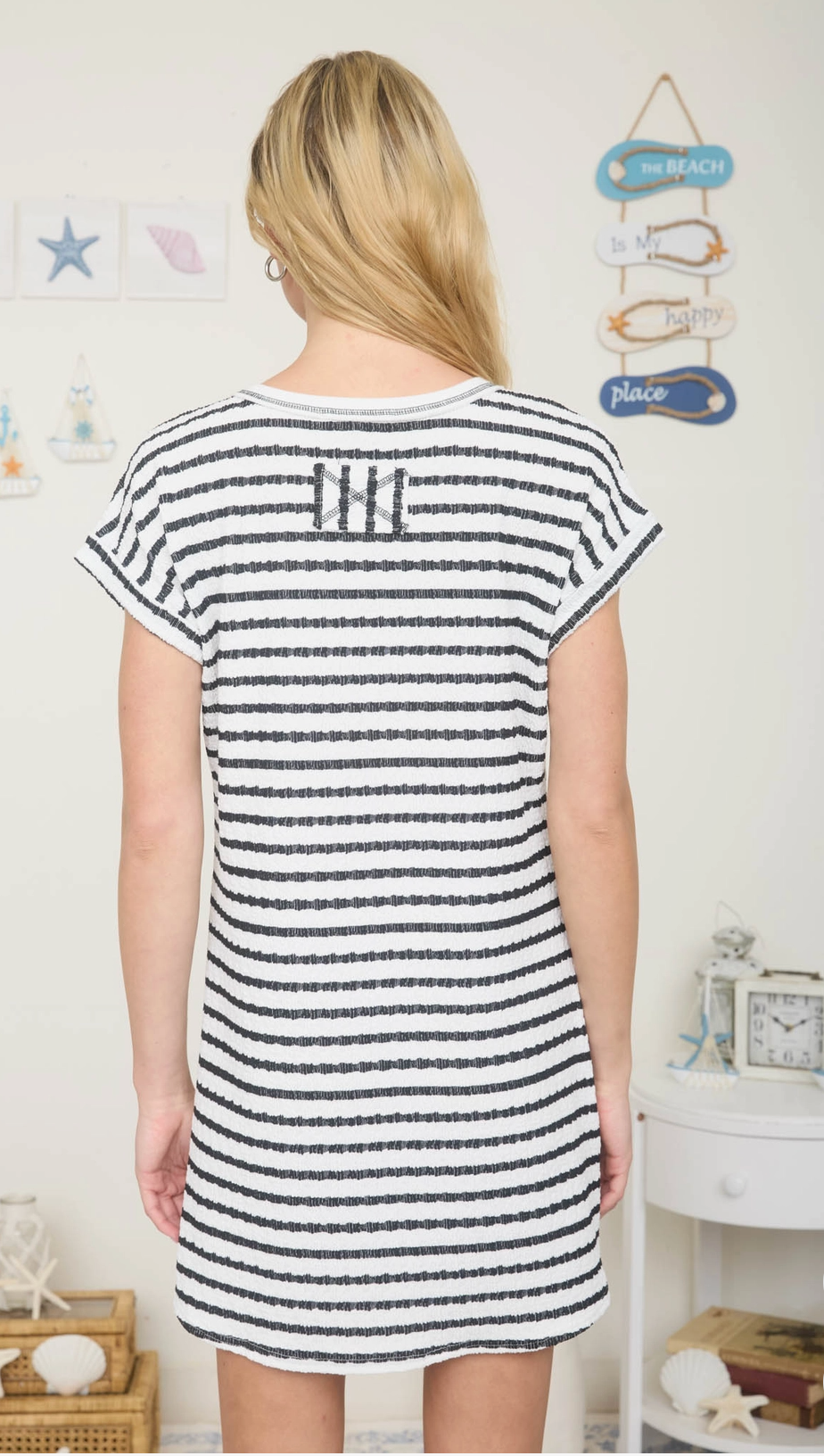 Black textured knit t-shirt mini dress with cuffed sleeves, pocket detail, and relaxed fit