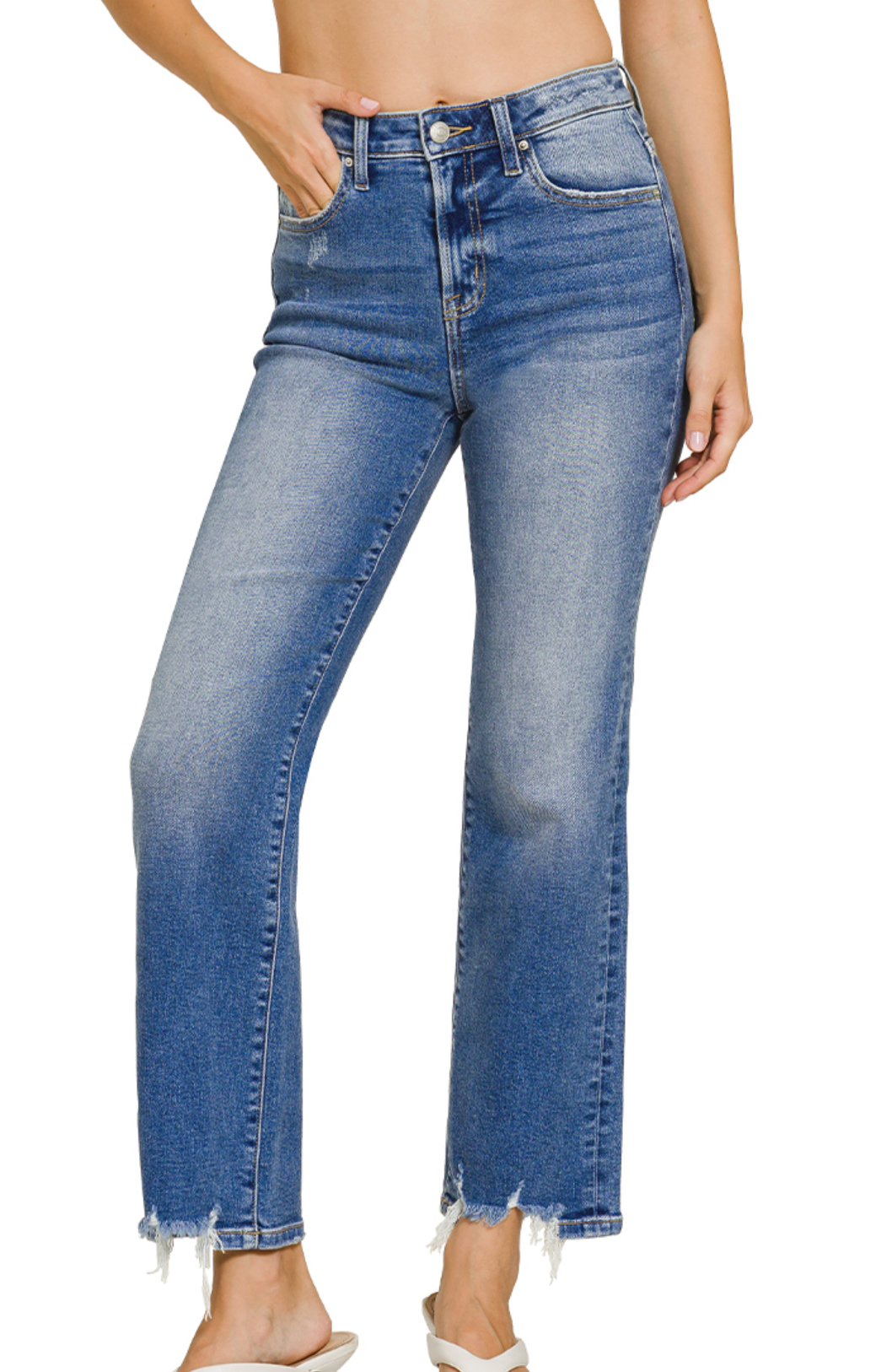 Stretch denim jeans with distressed frayed hem, cropped length, and medium wash finish